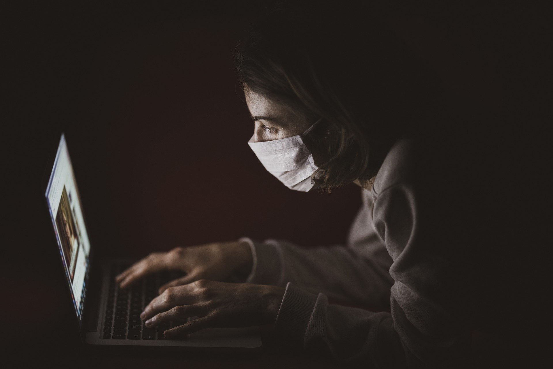 a doctor with a mask and a computer